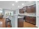 Open-concept kitchen with dark cabinets, stainless steel appliances, granite countertops, and a breakfast bar at 281 Decatur Dr, Summerville, SC 29486
