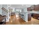 Open-concept living space featuring hardwood floors, stairs, a kitchen bar, and views into the living room at 281 Decatur Dr, Summerville, SC 29486
