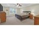 Comfortable main bedroom featuring a tray ceiling, ceiling fan, and a large window for natural light at 281 Decatur Dr, Summerville, SC 29486