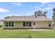 View of home's back exterior, showcasing multiple windows and a small patio at 2844 Curran Pl, Mount Pleasant, SC 29466