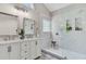 Bathroom featuring marble walk-in shower, dual sink vanity, and stylish patterned tile floor at 2844 Curran Pl, Mount Pleasant, SC 29466