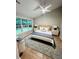 Serene bedroom featuring large windows, stylish rug, and ceiling fan at 2844 Curran Pl, Mount Pleasant, SC 29466