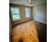 Bright bedroom featuring hardwood floors, neutral walls, and two windows at 2844 Curran Pl, Mount Pleasant, SC 29466