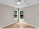 Cozy bedroom showcasing hardwood floors, neutral paint and bright windows at 2844 Curran Pl, Mount Pleasant, SC 29466