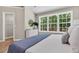 Bright bedroom featuring a large window with views of the surrounding trees at 2844 Curran Pl, Mount Pleasant, SC 29466
