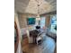 Bright dining room with modern chandelier, wainscoting, and large windows at 2844 Curran Pl, Mount Pleasant, SC 29466