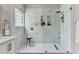Luxurious marble walk-in shower showcasing sleek fixtures and built-in shelving at 2844 Curran Pl, Mount Pleasant, SC 29466