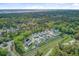 Stunning aerial view of homes nestled amongst lush trees with community pool and lake in the background at 2928 Tranquility Rd, Mount Pleasant, SC 29466