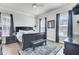 Primary bedroom with dark wood furniture, ceiling fan, natural light, and a wooden floor at 2928 Tranquility Rd, Mount Pleasant, SC 29466
