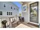 Inviting front porch featuring comfortable wicker seating with stylish black and white striped cushions at 2928 Tranquility Rd, Mount Pleasant, SC 29466