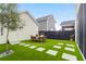 Backyard with artificial grass, pavers, and a dining table, perfect for outdoor entertaining at 3 Clearblue Loop, Summerville, SC 29486