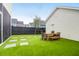 Artificial grass backyard including pavers, a dining table set, and perimeter fence for privacy at 3 Clearblue Loop, Summerville, SC 29486