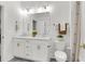 Bright bathroom with double vanity, brushed gold hardware, and decorative light fixtures at 3 Clearblue Loop, Summerville, SC 29486