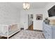 Bright Bedroom featuring hardwood floors, decorative accent wall, bassinet, crib, and decorative chandelier at 3 Clearblue Loop, Summerville, SC 29486