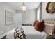 Bright bedroom featuring decorative chandelier, neutral decor, large bed, and natural light at 3 Clearblue Loop, Summerville, SC 29486