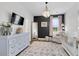Bright Bedroom featuring hardwood floors, black accent wall, bassinet, crib, and decorative chandelier at 3 Clearblue Loop, Summerville, SC 29486