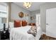 Bright bedroom featuring decorative chandelier, neutral decor, large bed, and natural light at 3 Clearblue Loop, Summerville, SC 29486