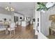 Open-concept living and dining area featuring modern lighting fixtures and hardwood floors, perfect for entertaining at 3 Clearblue Loop, Summerville, SC 29486