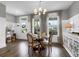 Bright dining room with a round table set for four, featuring hardwood floors, and ample natural light at 3 Clearblue Loop, Summerville, SC 29486