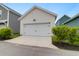 Detached garage with white siding and door, complementing the surrounding landscape at 3 Clearblue Loop, Summerville, SC 29486