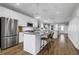 Modern kitchen with stainless steel appliances, white cabinetry, a spacious center island, and hardwood floors at 3 Clearblue Loop, Summerville, SC 29486
