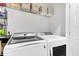Laundry room featuring front load washer and dryer and wire shelving with linen storage at 3 Clearblue Loop, Summerville, SC 29486