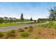 Picturesque neighborhood with a paved path winding along a scenic pond at 3 Clearblue Loop, Summerville, SC 29486