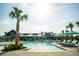 A beautiful community pool features palm trees, lounge chairs, and umbrellas for a resort-style living experience at 3 Clearblue Loop, Summerville, SC 29486