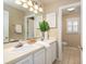 Bathroom with double sinks, white cabinets, and a separate toilet area at 30 Beachside Dr, Isle of Palms, SC 29451