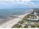 Aerial shot of the beach, showcasing the pier and beachside area with clear waters and sunny skies at 30 Beachside Dr, Isle of Palms, SC 29451