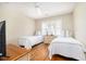 Bright bedroom with hardwood floors, twin beds, and plantation shutters at 30 Beachside Dr, Isle of Palms, SC 29451