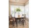 Cozy breakfast nook with charming wooden table, chairs, and bright natural light from shuttered windows at 30 Beachside Dr, Isle of Palms, SC 29451