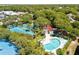 Overhead view of the community pool and tennis courts with shade structures and green spaces for leisure at 30 Beachside Dr, Isle of Palms, SC 29451