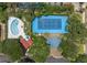 Aerial view of the community pool, tennis court, and recreational area surrounded by lush greenery at 30 Beachside Dr, Isle of Palms, SC 29451