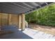 A shady covered patio with a swing and space for outdoor enjoyment at 30 Beachside Dr, Isle of Palms, SC 29451