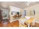 The bright dining area features hardwood floors, a large table, and convenient access to the kitchen at 30 Beachside Dr, Isle of Palms, SC 29451