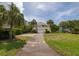 Charming two-story home features lush landscaping, a driveway, and a two-car garage at 30 Beachside Dr, Isle of Palms, SC 29451
