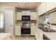 Traditional kitchen with light cabinets, stainless steel appliances and a light-wood planked ceiling at 30 Beachside Dr, Isle of Palms, SC 29451