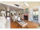 Spacious living room with hardwood floors, a fireplace, comfortable seating, and a dining area at 30 Beachside Dr, Isle of Palms, SC 29451