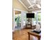 Cozy living room showcasing hardwood floors, a view to the screened porch, and natural lighting at 30 Beachside Dr, Isle of Palms, SC 29451