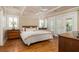 Airy main bedroom with hardwood floors, sitting area, and access to screened porch at 30 Beachside Dr, Isle of Palms, SC 29451