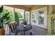 Relaxing screened porch with stylish furniture, greenery, and an ocean vibe at 30 Beachside Dr, Isle of Palms, SC 29451