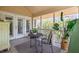 Inviting screened porch with comfortable seating and view to the outdoors at 30 Beachside Dr, Isle of Palms, SC 29451