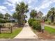Charming street view of a well-maintained property with mature palm trees and manicured landscaping at 30 Beachside Dr, Isle of Palms, SC 29451
