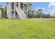 A view of backyard with stair leading to the porch and a lush green lawn at 3029 Robeson Trce, Johns Island, SC 29455