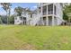 Expansive backyard of a charming two-story home with white stairs and manicured lawn at 3029 Robeson Trce, Johns Island, SC 29455