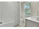 Bright bathroom with subway tile, patterned floor, and a window with a view at 3029 Robeson Trce, Johns Island, SC 29455