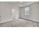 Neutral carpeted bedroom with window and attached bathroom featuring a shower and tub at 3029 Robeson Trce, Johns Island, SC 29455