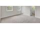 Bright bedroom with neutral walls and carpet flooring and large windows overlooking trees at 3029 Robeson Trce, Johns Island, SC 29455