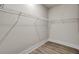 Empty walk-in closet with wire shelving and wood-look flooring at 3029 Robeson Trce, Johns Island, SC 29455